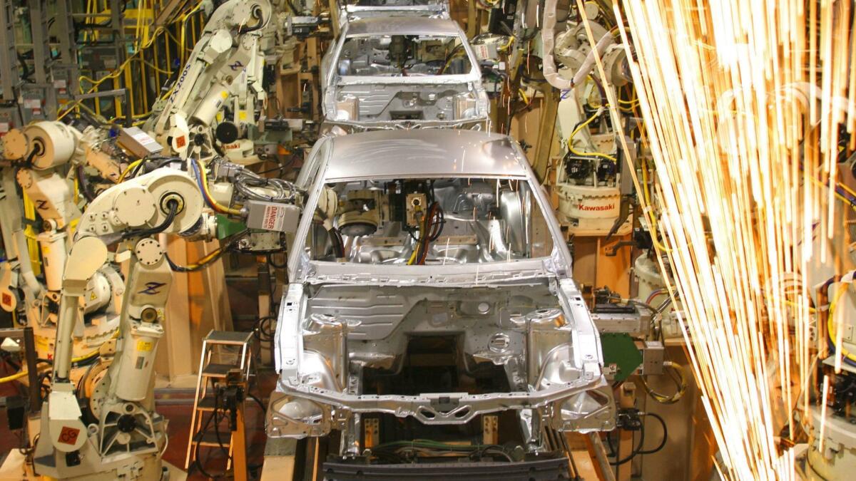 Ford Mustangs being assembled at its plant in Flat Rock, Mich., in 2004.