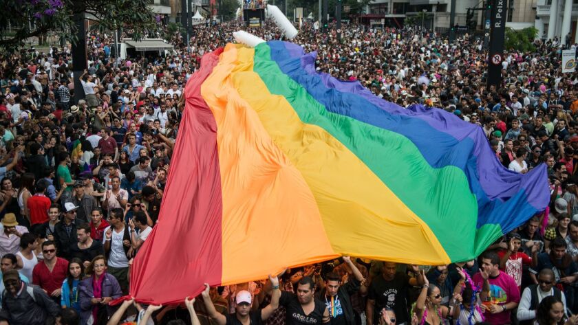 A huge rainbow flag is unfolded during the annual gay pride parade in Sao Paulo, Brazil, on June 10, 2012.