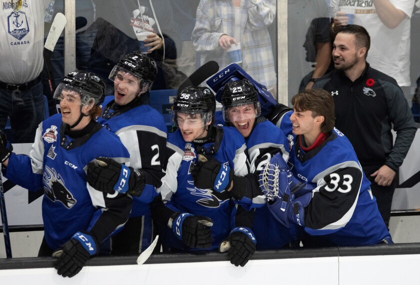 Saint John Sea Dogs' Jeremie Poirier, Yan Kuznetsov, Charlie DesRoches, Nathan Drapeau and Thomas Couture, from left, start to celebrate as the clock winds down in the third period of the team's Memorial Cup hockey final against the Hamilton Bulldogs, Wednesday, June 29, 2022, in Saint John, New Brunswick. (Ron Ward/The Canadian Press via AP)