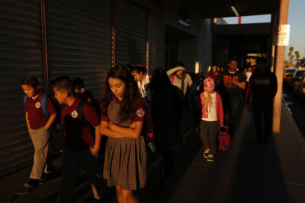 Students walk to school after crossing the border in Calexico, Calif.