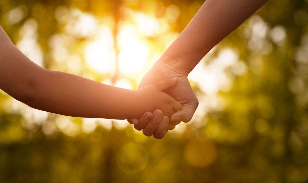 holding hands in sunlight