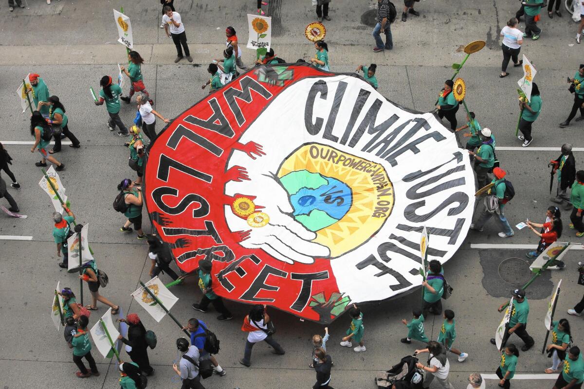 Demonstrators march in New York on Sunday to call attention to global warming. A United Nations climate summit is to begin Tuesday in New York.