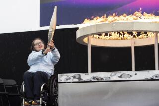 British Paralympian Helene Raynsford holds the Paralympic Torch during the flame lighting ceremony in Stoke Mandeville