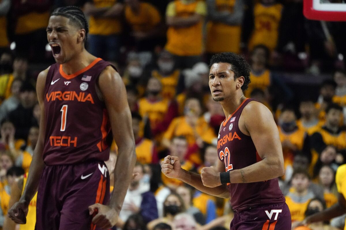 Virginia Tech forward David N'Guessan (1) and forward Keve Aluma (22) react after a basket against Maryland during the second half of an NCAA college basketball game, Wednesday, Dec. 1, 2021, in College Park, Md. Virginia Tech won 62-58. (AP Photo/Julio Cortez)