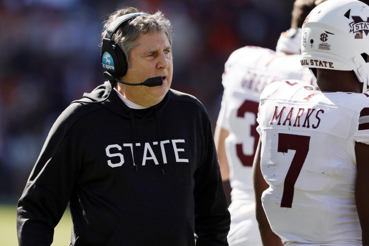 Mississippi State coach Mike Leach talks with players during a timeout against Auburn in November 2021.