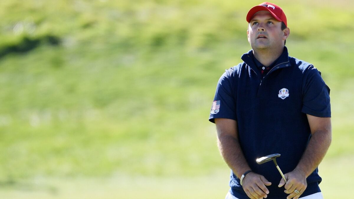 Patrick Reed reacts to a putt during singles matches at the 2018 Ryder Cup on Sept. 30 in Paris.