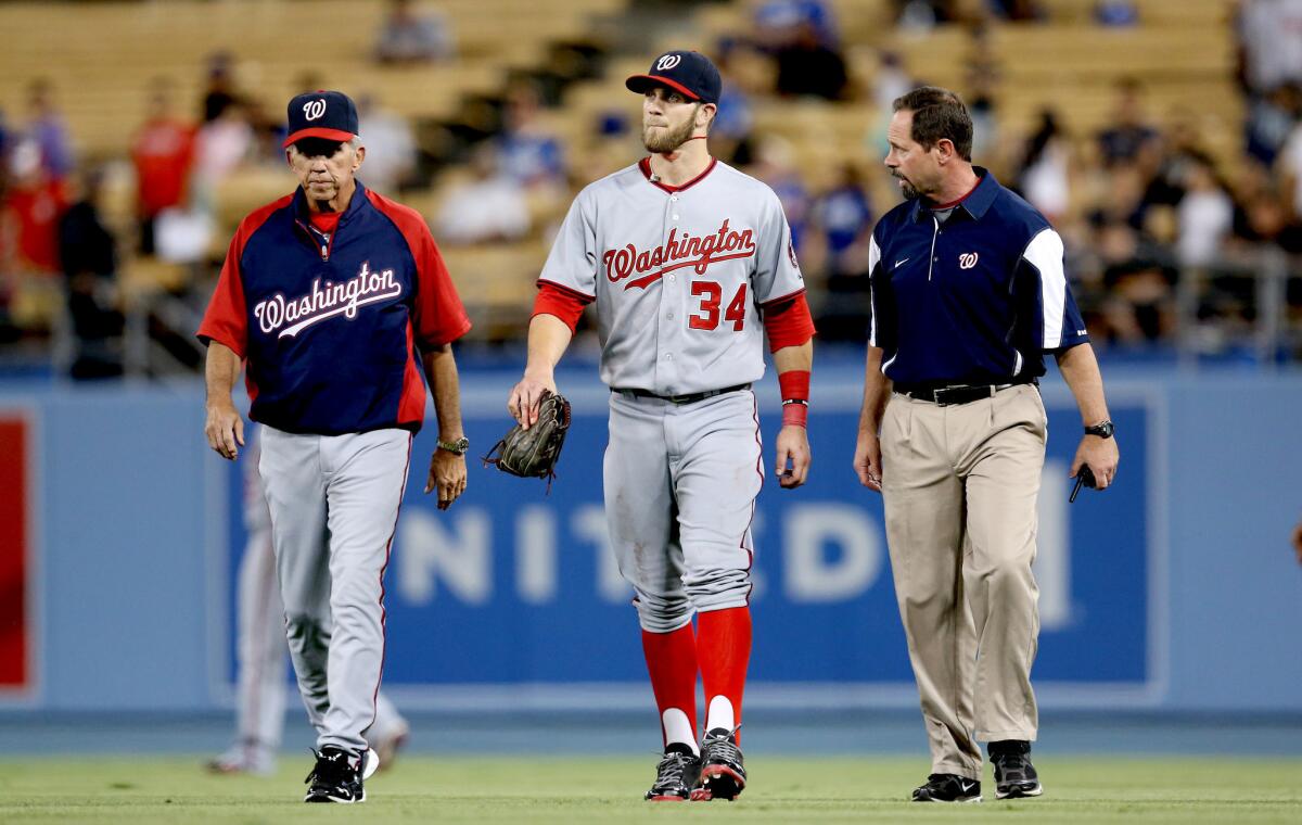 Washington Nationals right fielder Bryce Harper (34) walks off the field after running into the wall in the fifth inning.