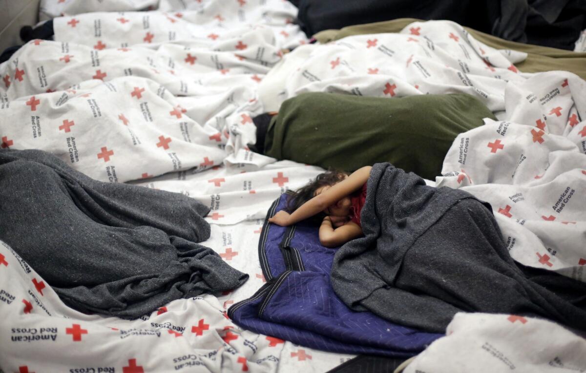 Child immigrant detainees sleep in a holding cell in Brownsville, Texas.