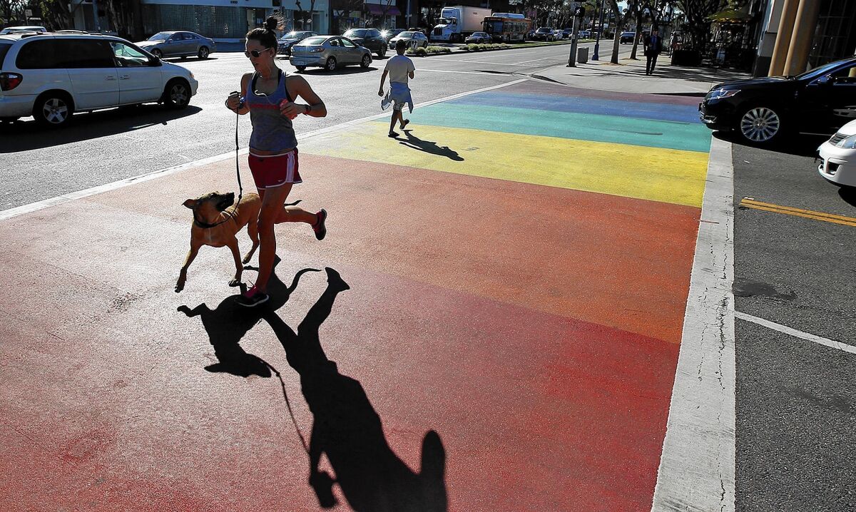 Though West Hollywood is becoming more diverse, as straight residents and business owners join the hip community, local officials say they have no intention of shying away from the city's historic gay identity, which led to rainbow crosswalks and flags at traffic medians.