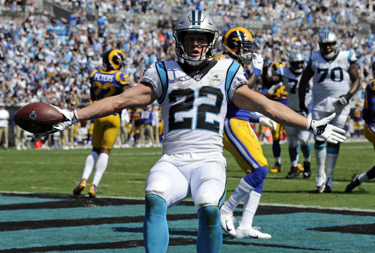 Panthers running back Christian McCaffrey (22) celebrates after scoring a touchdown against the  Rams in Week 1. 