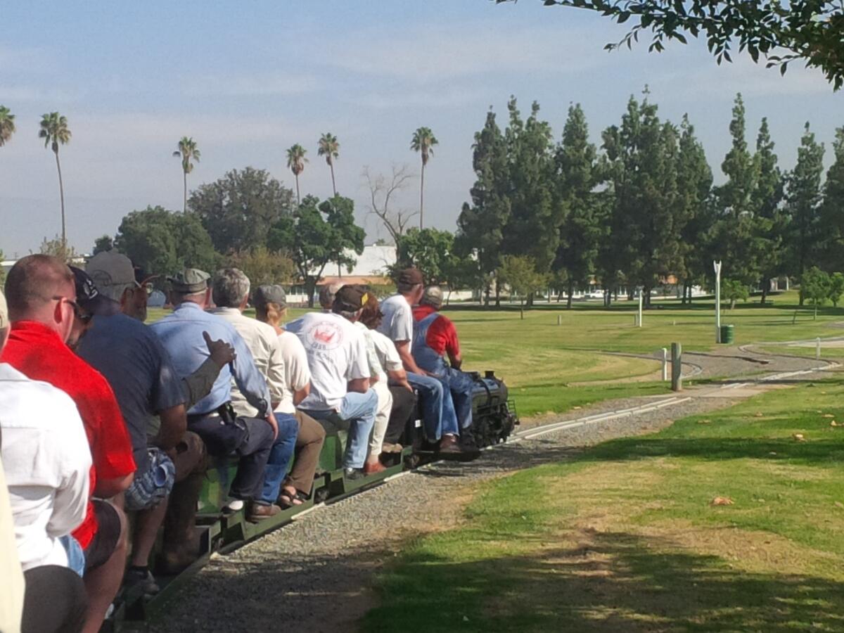 Members of the Fairview Park Citizens Advisory Committee ride the train Sunday in Hunter Hobby Park in Riverside. The Riverside Live Steamers, a train hobbyist group, led the tour so the committee could see a park where rideable trains and sports facilities coexist.