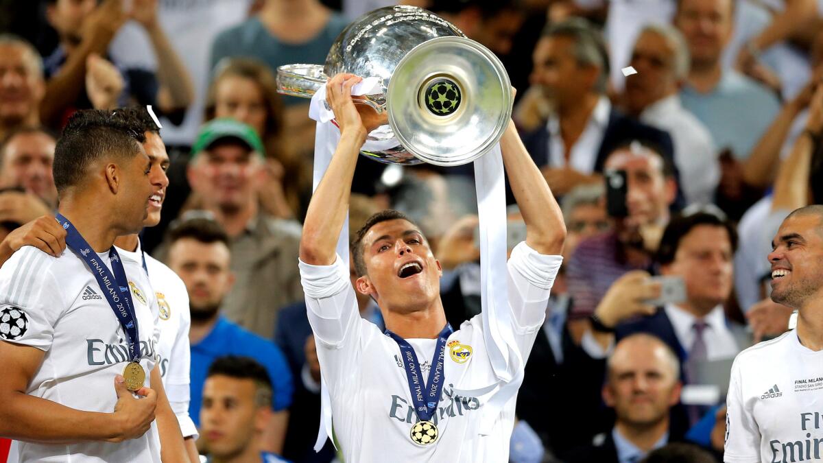 Cristiano Ronaldo hoists the trophy after Real Madrid won the Champions League final Saturday.