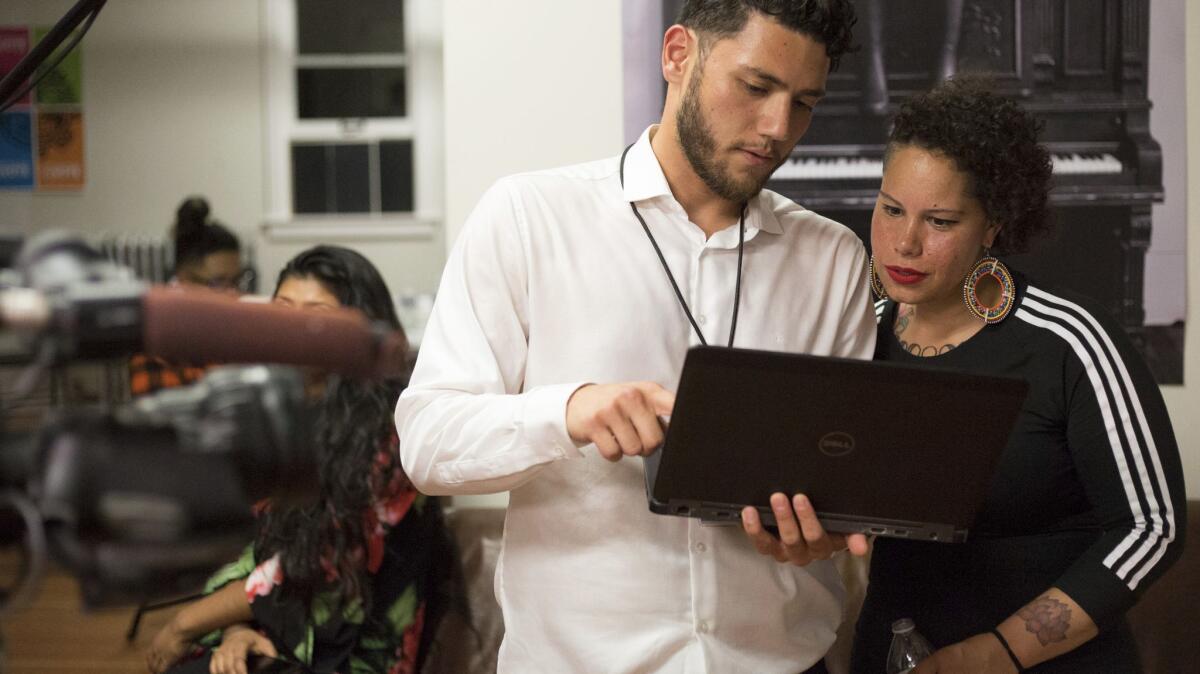 Seattle mayoral candidate Nikkita Oliver works with communications director Dujie Tahat on a news release. She finished third in a crowded primary.