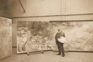 An aged Claude Monet, with a long beard, poses before one of his water lily canvases while holding a painter's palette