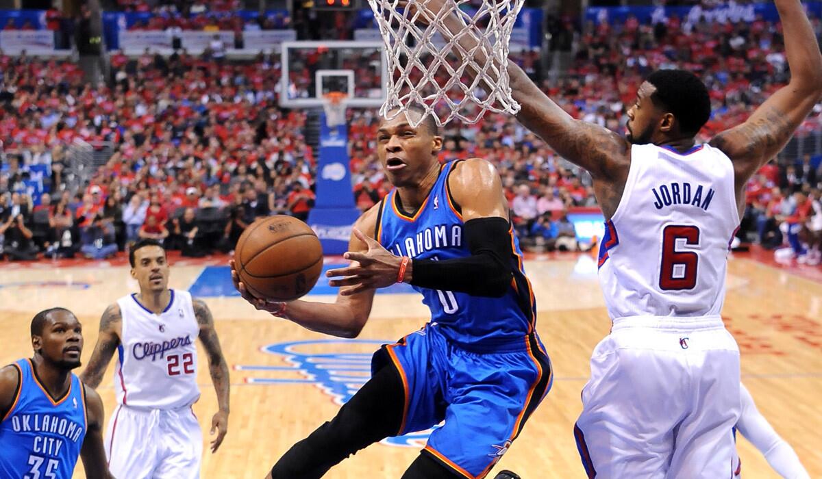 Thunder point guard Russell Westbrook gets past Clippers center DeAndre Jordan for a layup in Game 3.