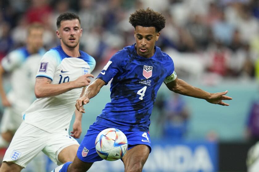 Tyler Adams of the United States, right, fights for the ball against England's Mason Mount.
