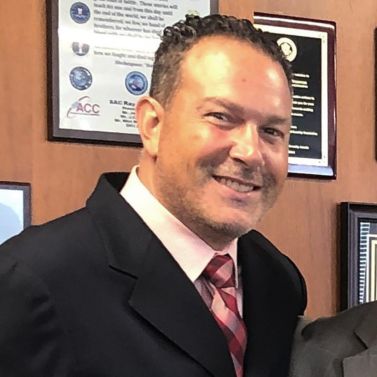 A closeup of a man in a tie and jacket