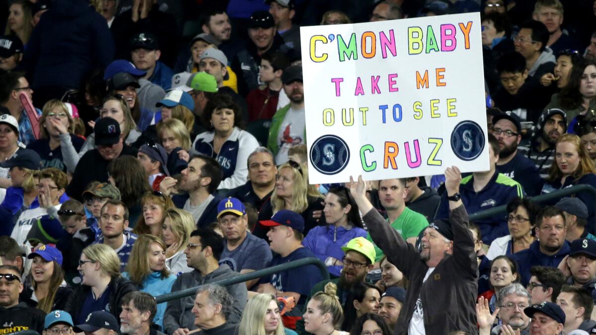 A Seattle Mariners fan holds a sign supporting slugger Nelson Cruz during a game against the Kansas City Royals on April 30.