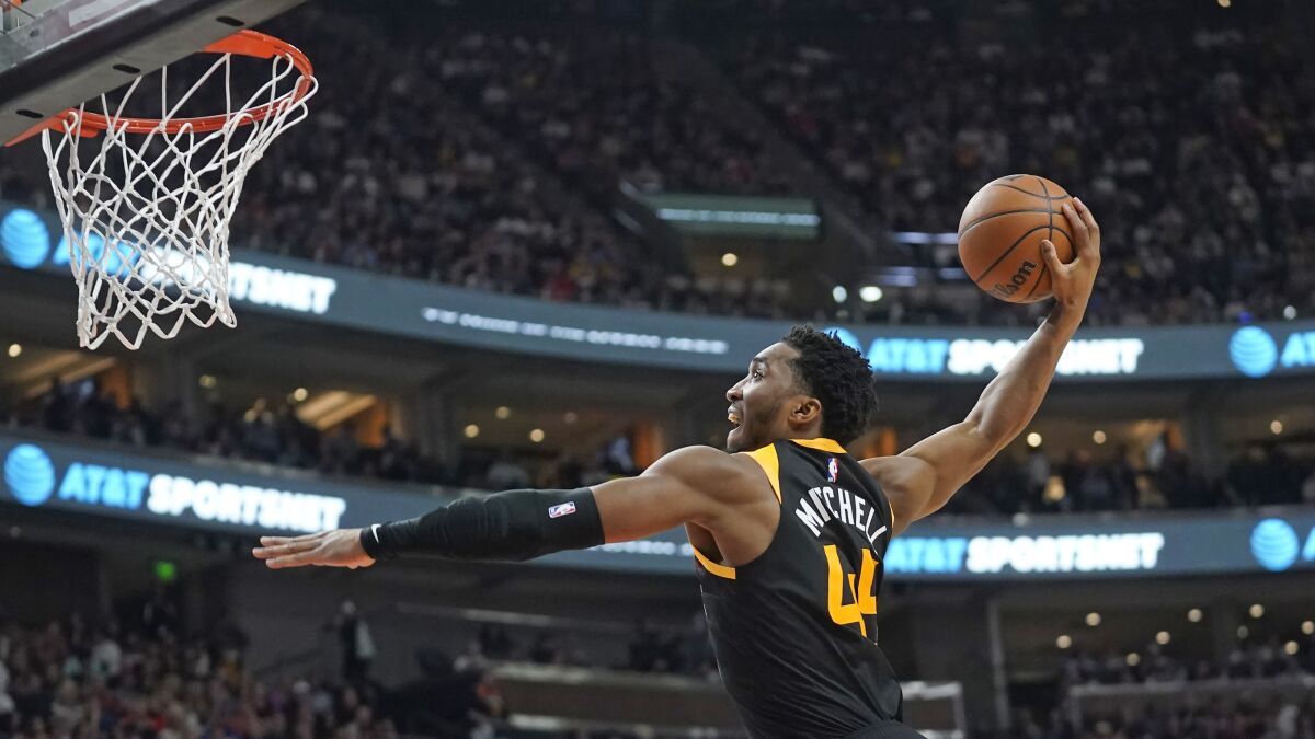 Utah Jazz guard Donovan Mitchell goes to the basket for a dunk against the Los Angeles Lakers during the second half of an NBA basketball game Thursday, March 31, 2022, in Salt Lake City. (AP Photo/Rick Bowmer)
