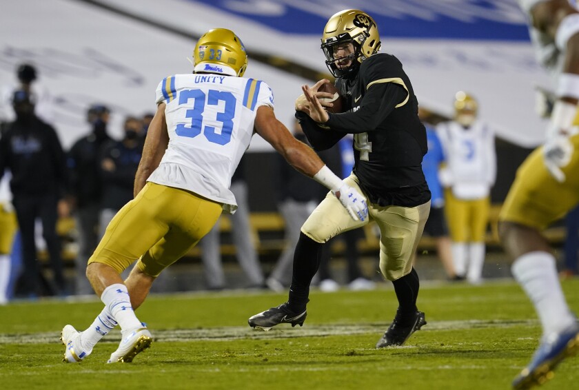 UCLA linebacker Bo Calvert looks to tackle Colorado quarterback Sam Noyer.