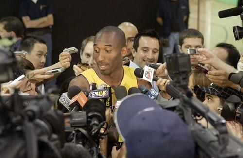 Lakers guard Kobe Bryant is engulfed by reporters during the Lakers Media Day on Monday at the Lakers' training facility in El Segundo.