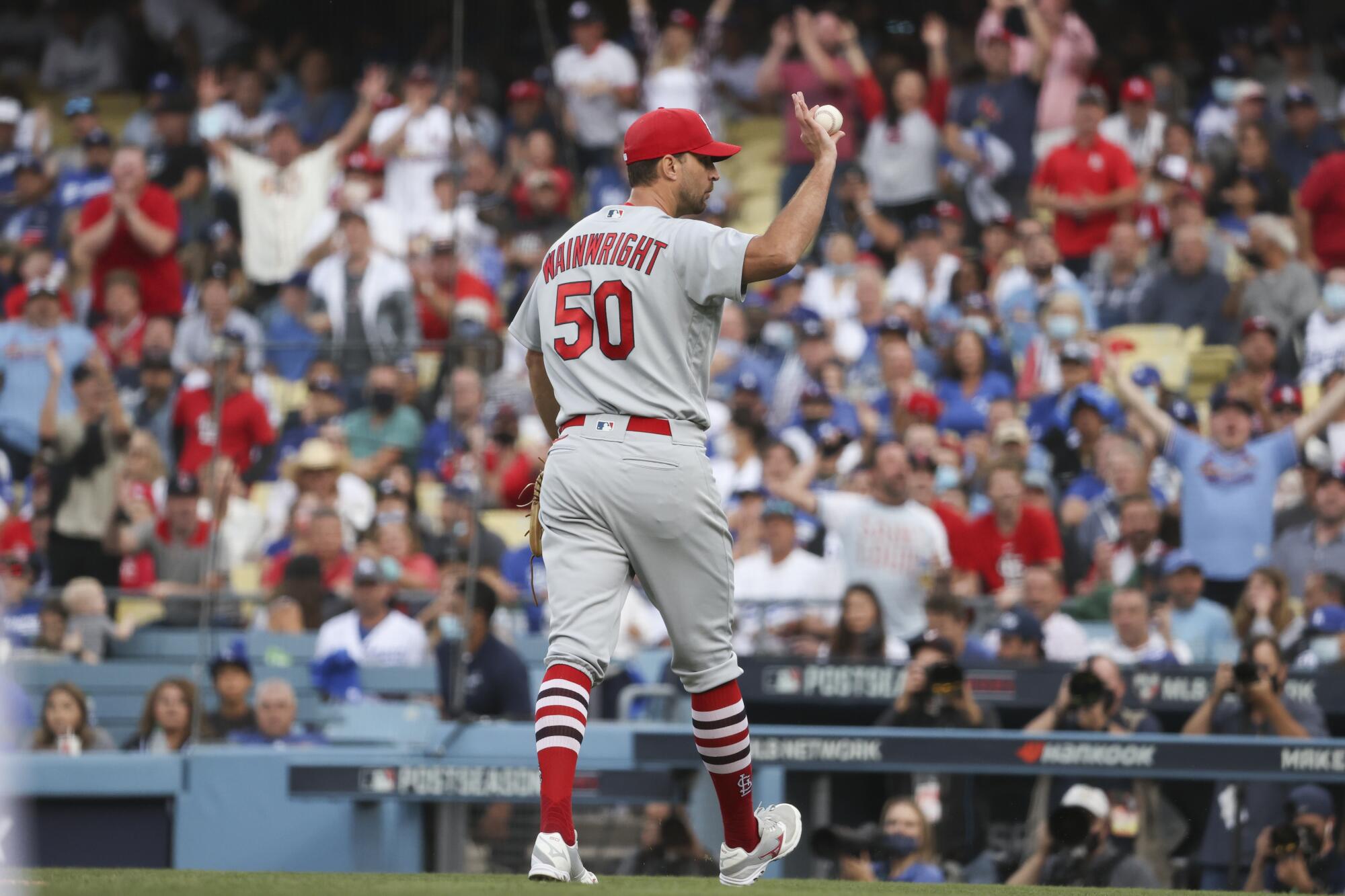 Louis Cardinals starting pitcher Adam Wainwright waves while leaving the field