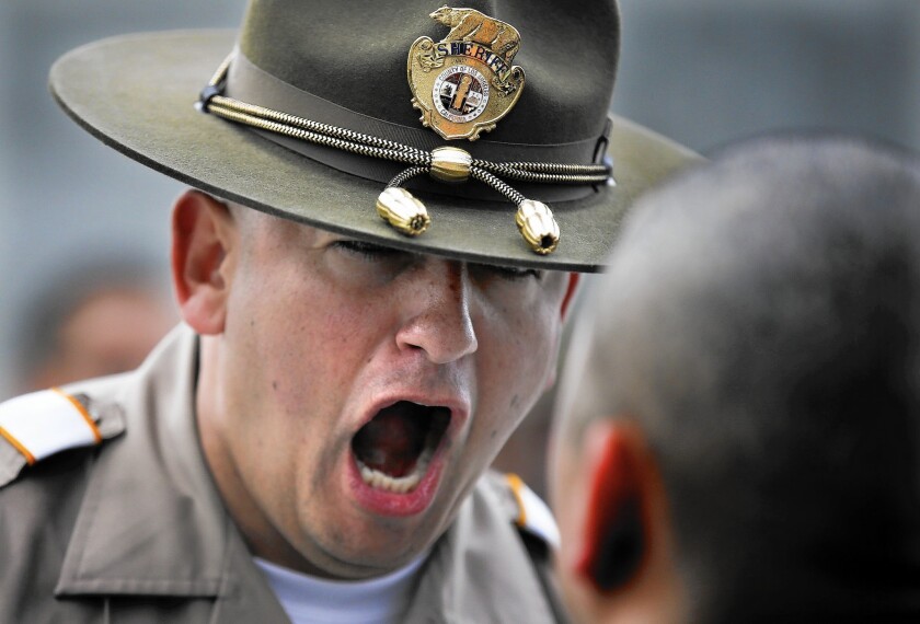 L.A. County Sheriff's Deputy Guillermo Martinez gets in the face of a recruit on his first day at the Biscailuz Regional Training Center in Monterey Park. For every 100 applicants, only two or three end up wearing the badge.