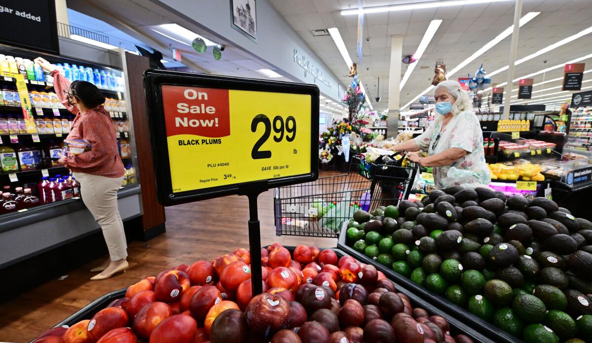 People shop at a grocery supermarket in Alhambra, Calif. Consumer price increases remained high last month.
