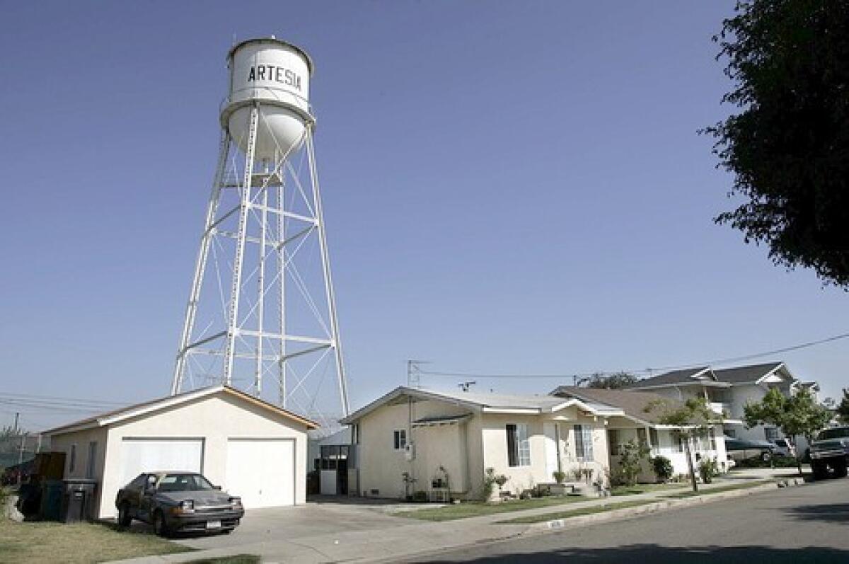 The Artesia Water Tower sits behind a home on Clarkdale Ave.