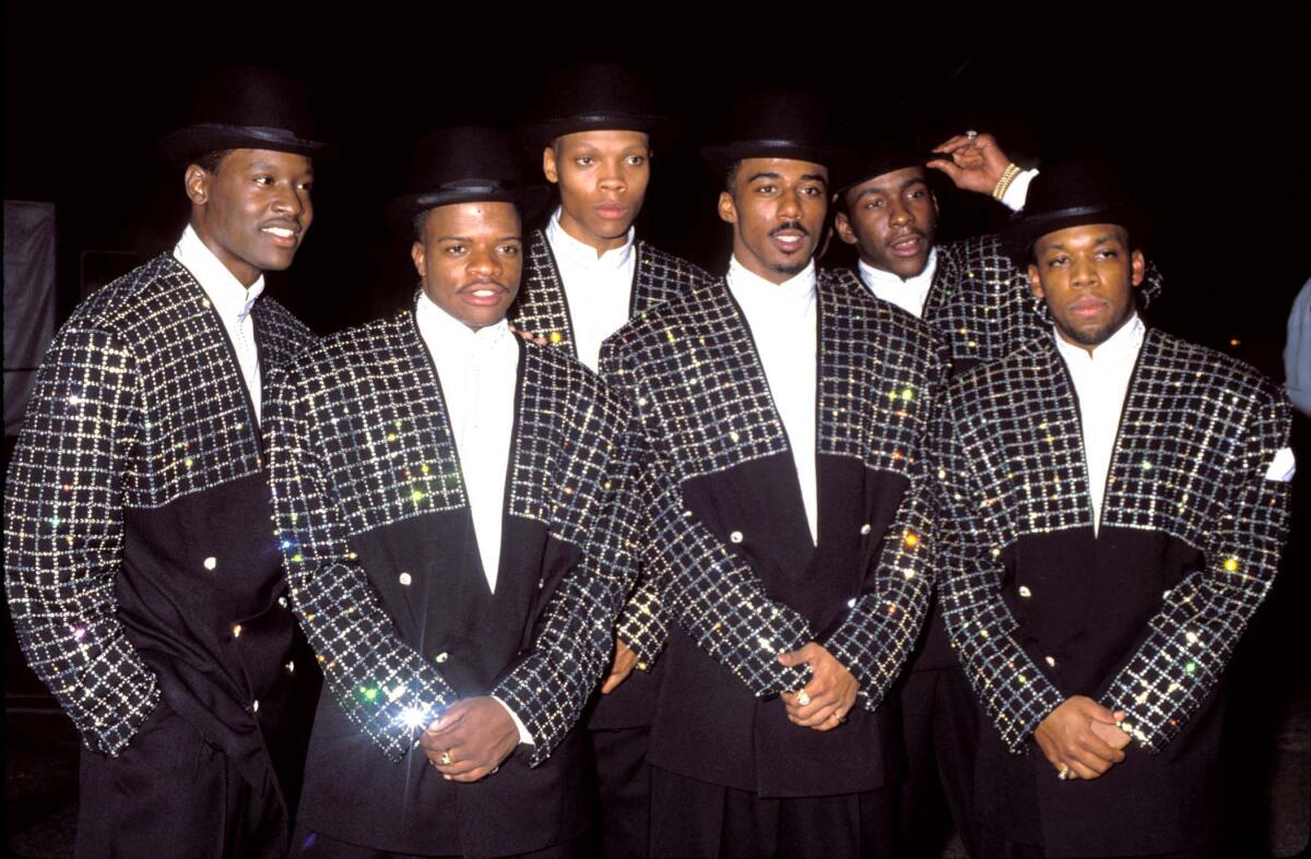 Six men in matching suits and hats