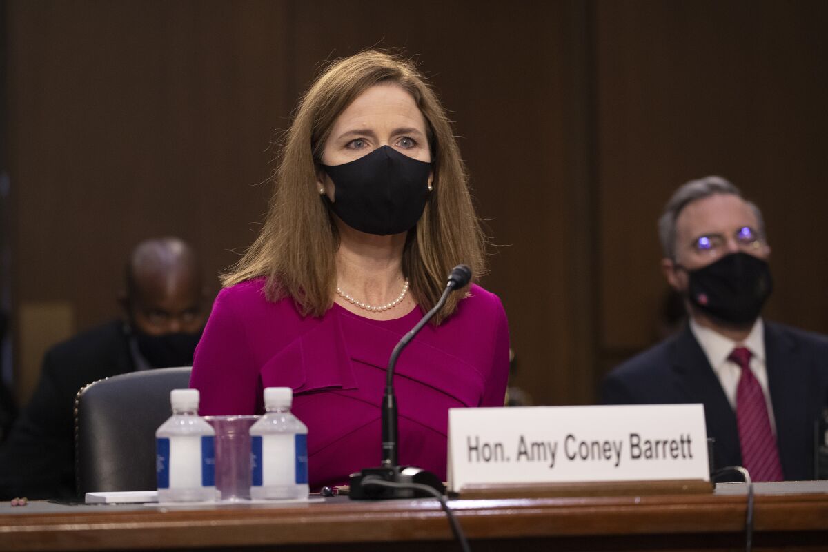 Supreme Court nominee Amy Coney Barrett wears a mask during her confirmation hearing on Capitol Hill.