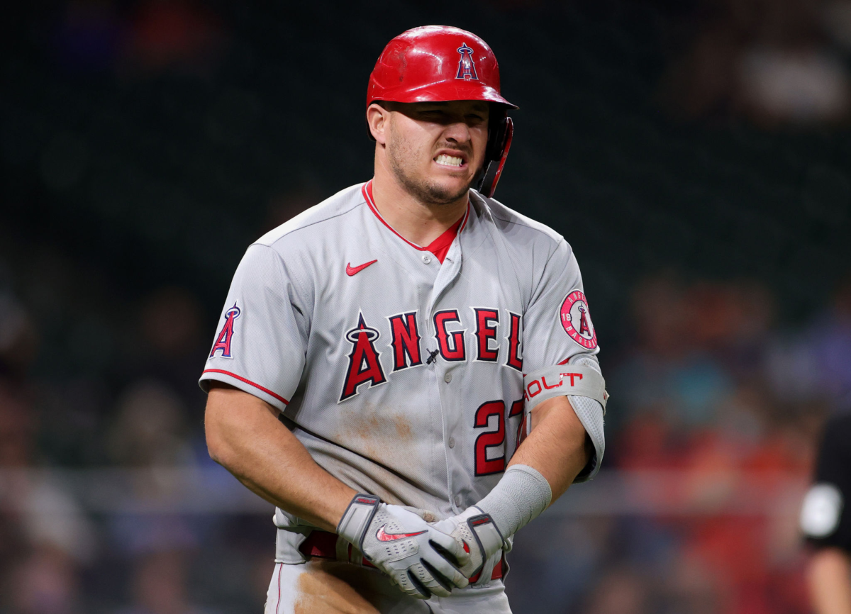 Angels slugger Mike Trout grimaces after being hit by a pitch against the Houston Astros on Thursday.