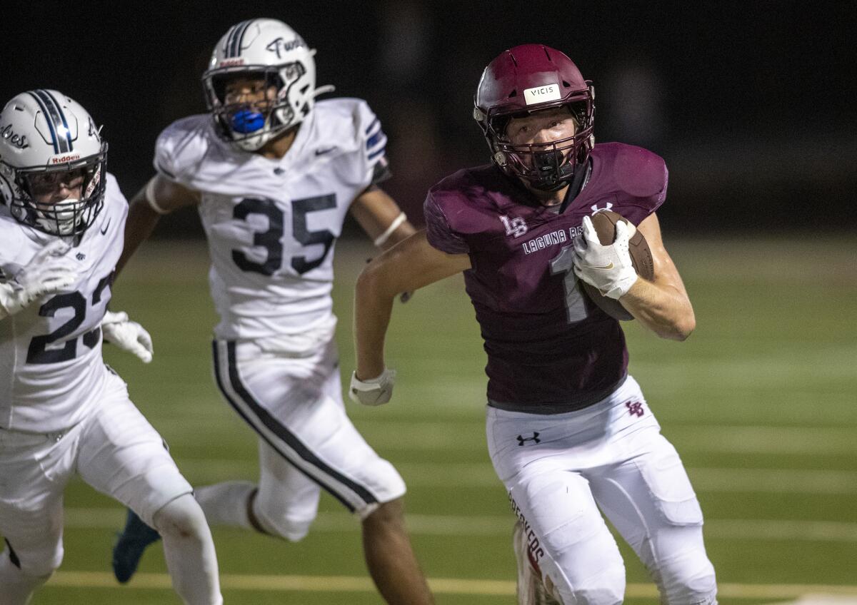 Laguna Beach's Nick Rogers beats Northwood's Lucas Trausch, left, and Kaden Carter during a nonleague game on Friday.