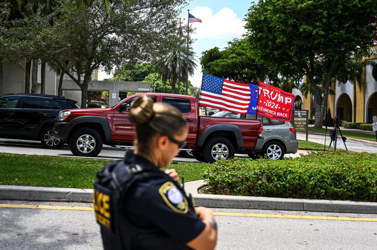 Supporters of Donald Trump drive around the federal courthouse in West Palm Beach, Fla., during an Aug. 18 hearing.