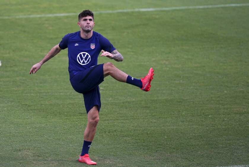 United States' Christian Pulisic warms up during a training session ahead of the World Cup 2022 qualifying soccer match against Jamaica in Kingston, Monday, Nov. 15, 2021.(AP Photo/Fernando Llano)