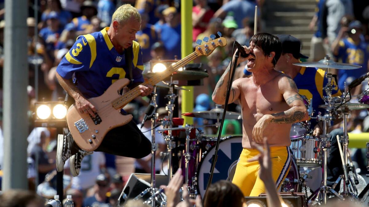 Flea and Anthony Kaedis from the Red Hot Chili Peppers perform before the Rams-Seahawks game.