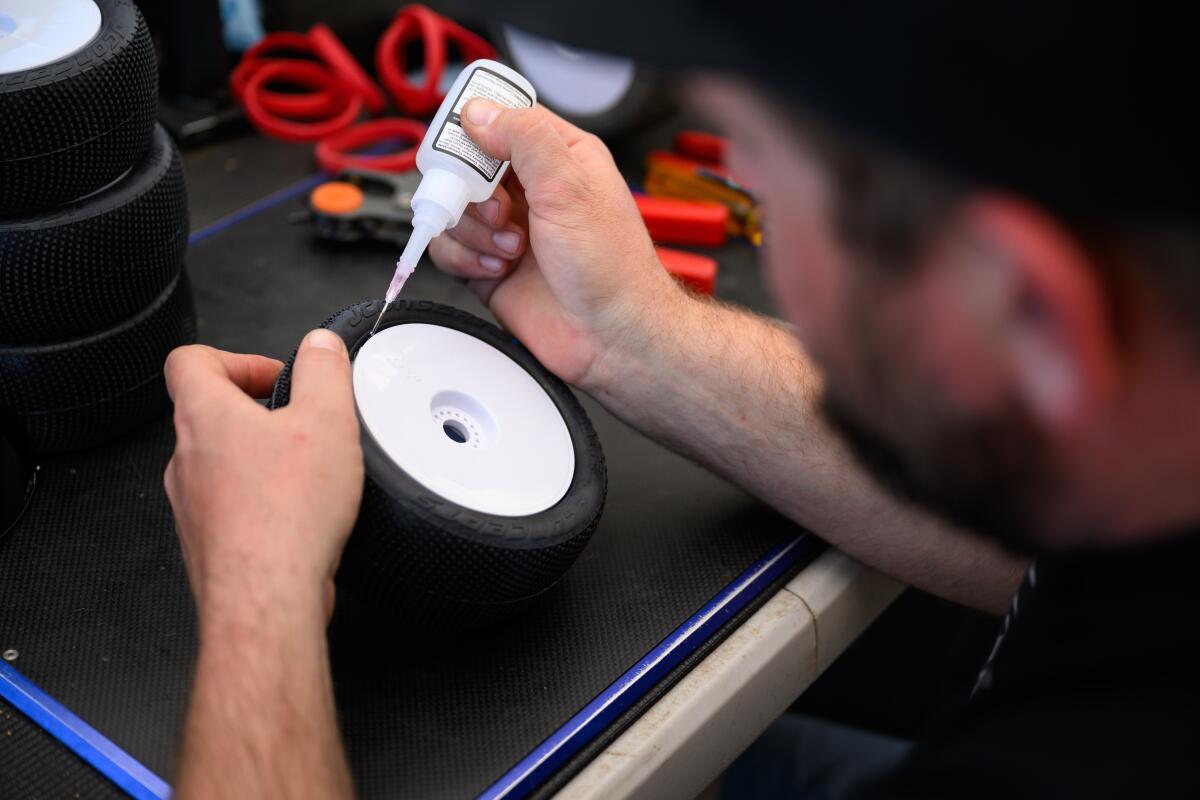 Ryan Maifield puts super glue on tires