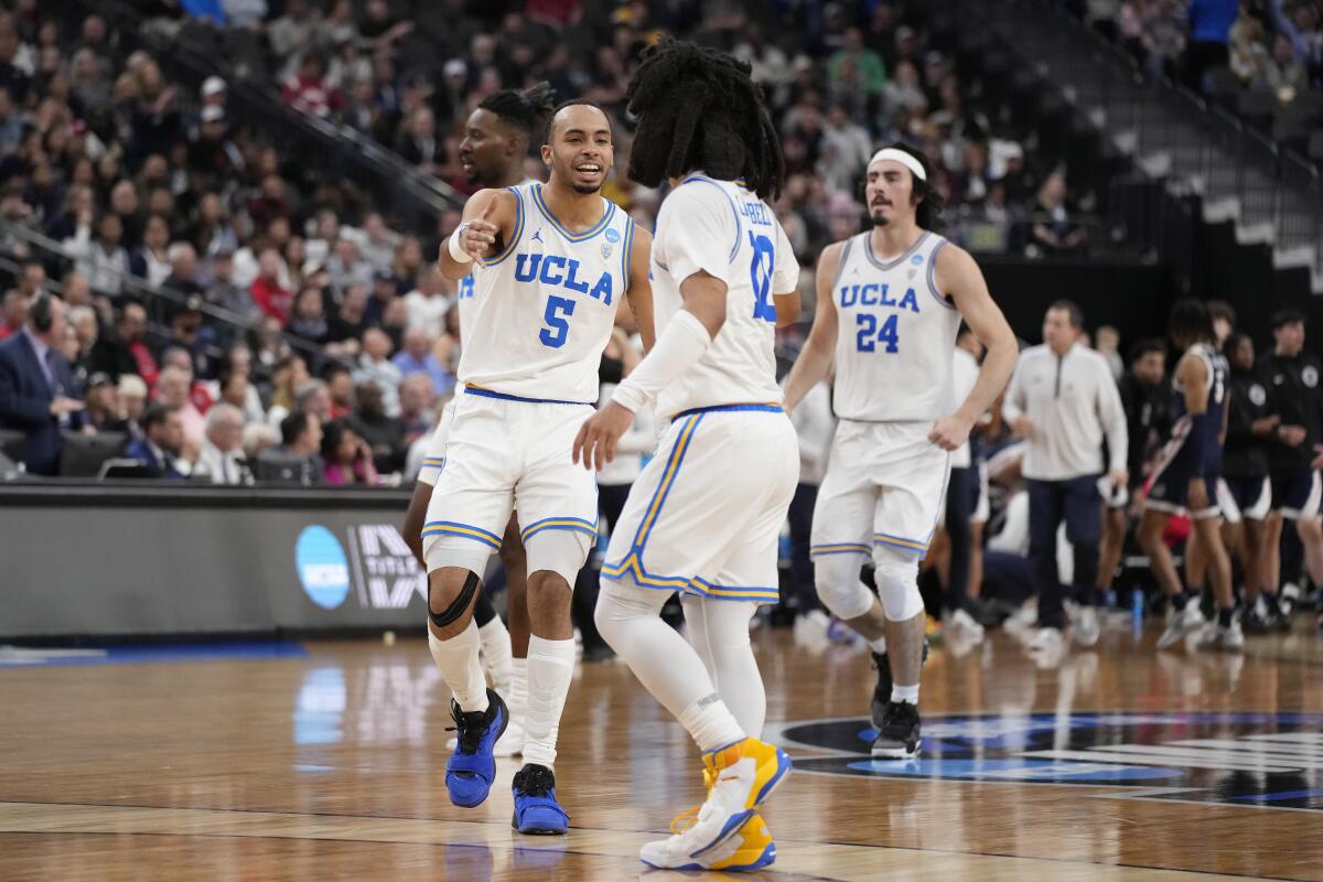 UCLA's Amari Bailey and Tyger Campbell celebrate during the first half against Gonzaga on Thursday.