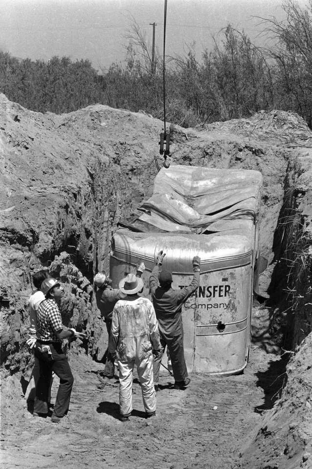 In this file photo, officials remove a truck buried at a quarry in Livermore, Calif., in which 26 Chowchilla schoolchildren and their bus driver, Ed Ray, were held captive.