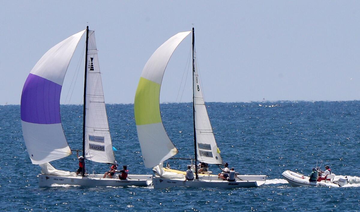 Leonard Takahashi of the Royal New Zealand Yacht Squadron, left, sails against Frank Dair of the California Yacht Club in the semifinals of the 53rd annual Governor's Cup off the coast of Newport Beach on Friday.