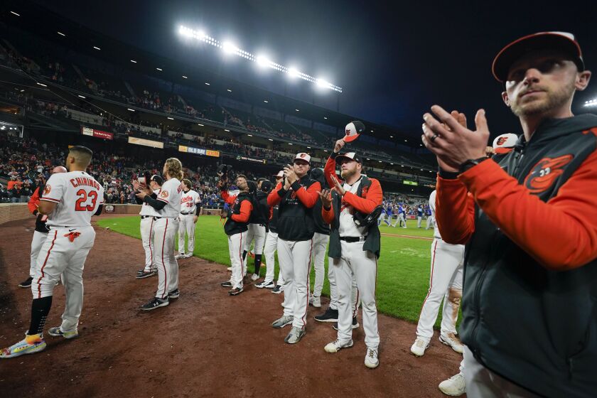 Baltimore Orioles players acknowledge spectators after the second game of a baseball doubleheader against the Toronto Blue Jays, Wednesday, Oct. 5, 2022, in Baltimore. The Blue Jays won 5-1. (AP Photo/Julio Cortez)