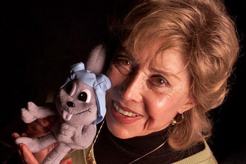 June Foray poses with Rocky the Flying Squirrel.
