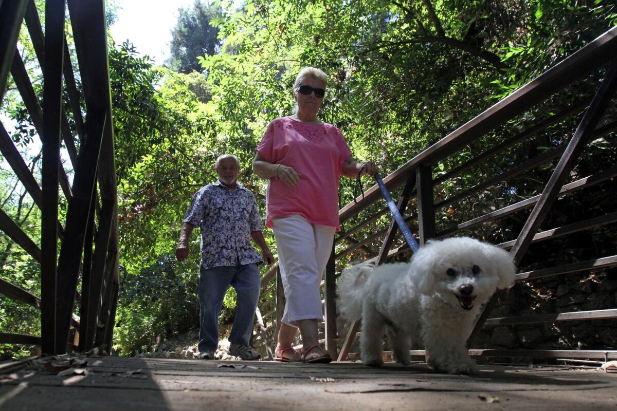 Gary Krieger and his wife, Karen Pickette, of Palmdale, walk their dog through the Fern Dell Grotto.