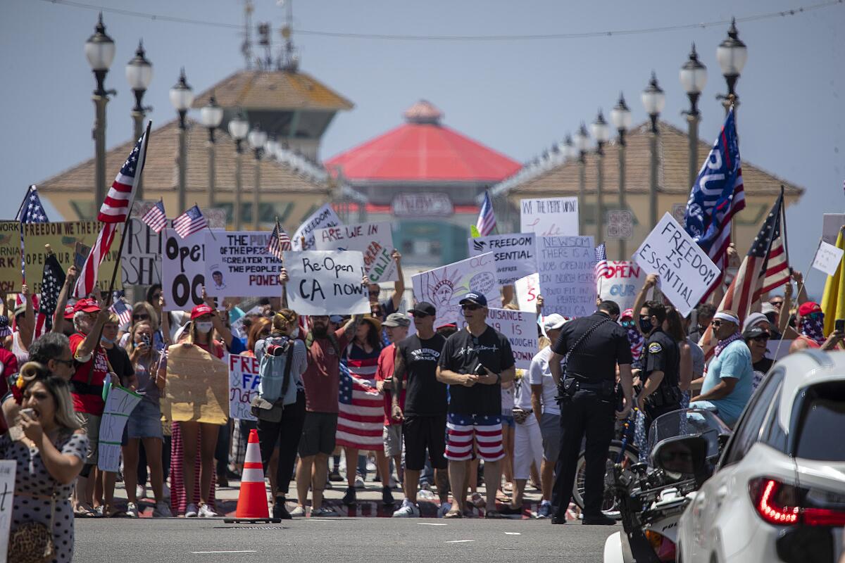 Huntington Beach protesters, many unmasked, rally against COVID restrictions on May 1.
