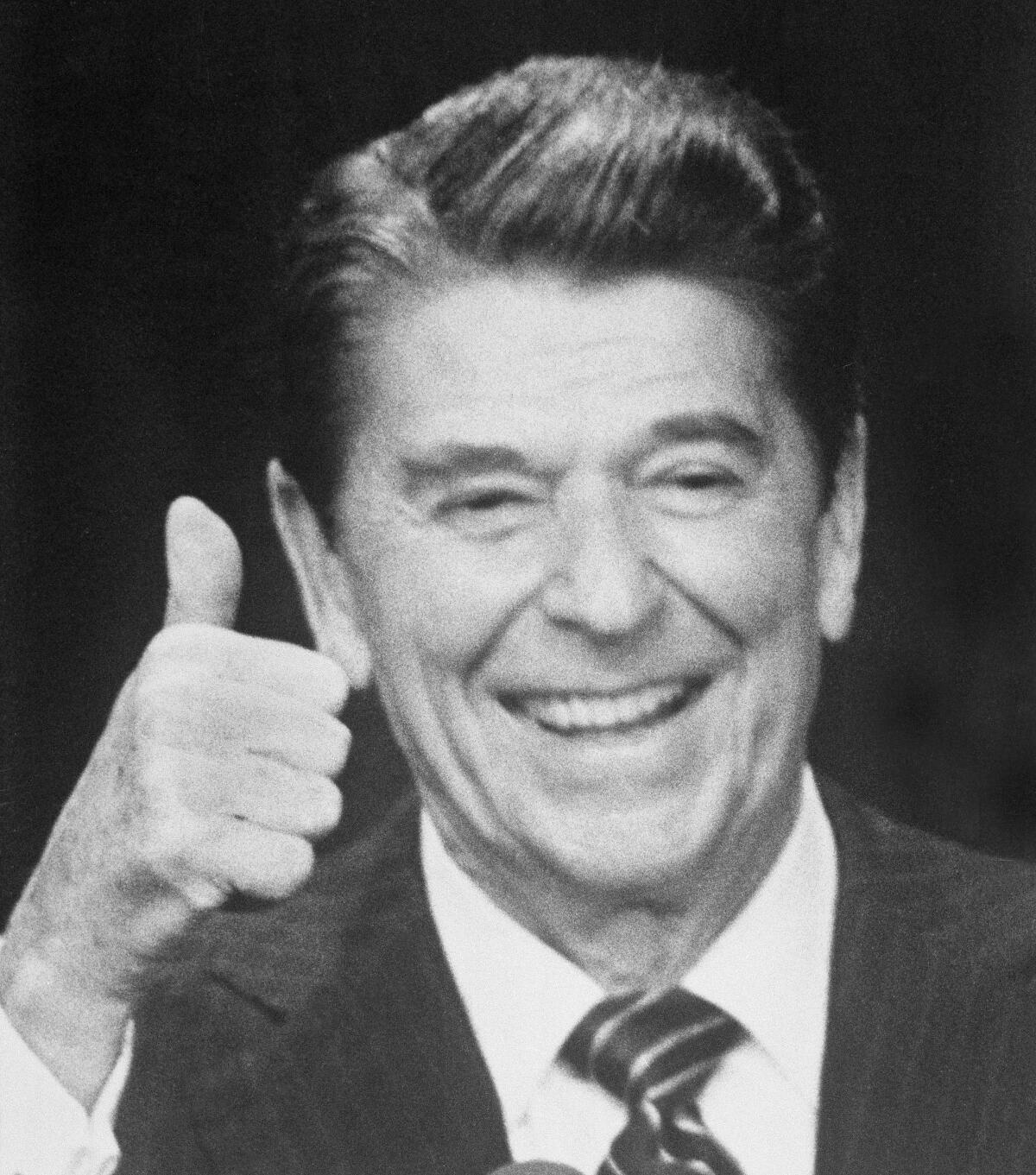 President Reagan smiles and gives a thumbs up