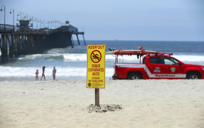 Signs warn of contaminated ocean water in Imperial Beach on Thursday. Imperial Beach frequently has to close its shorline because of water pollution caused by cross-border sewage spills.
