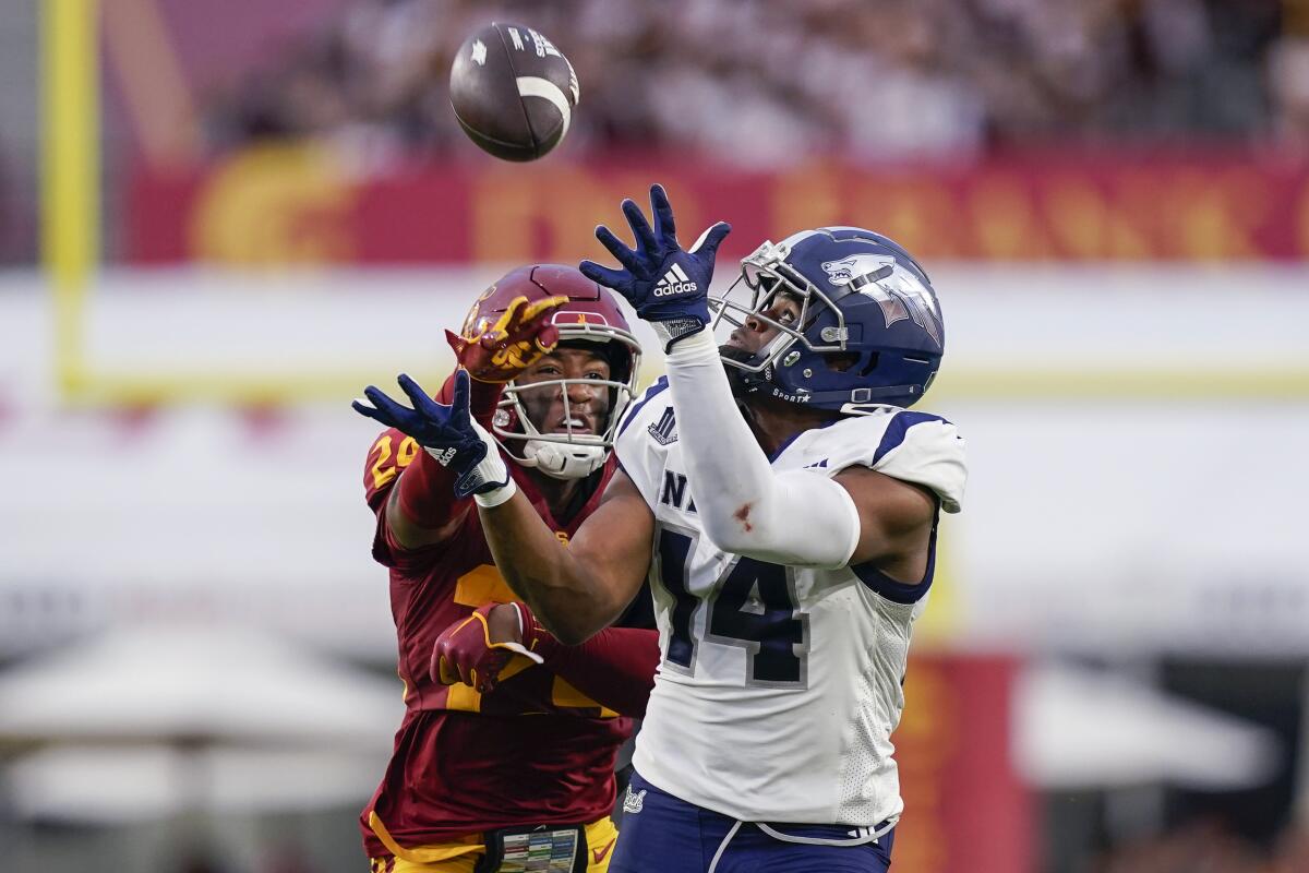 Nevada receiver John Jackson III catches a pass in front of USC safety Christian Pierce 