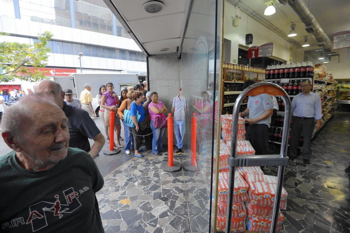 People line up for soap in Caracas, Venezuela, in February.