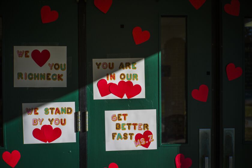 FILE - Messages of support for teacher Abby Zwerner, who was shot by a 6-year-old student, grace the front door of Richneck Elementary School Newport News, Va., on Jan. 9, 2023. According to a Tuesday, Jan. 24, 2023, media advisory, the first-grade teacher from Virginia who was shot and seriously wounded by a 6-year-old student, has hired a trial attorney to represent her. (AP Photo/John C. Clark, File)