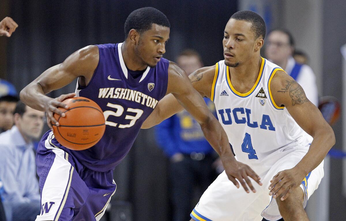 Former University of Washington guard C.J. Wilcox drives against UCLA guard Norman Powell on Feb. 7.